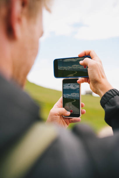 istock Young man takes photo in mountains 1501209516