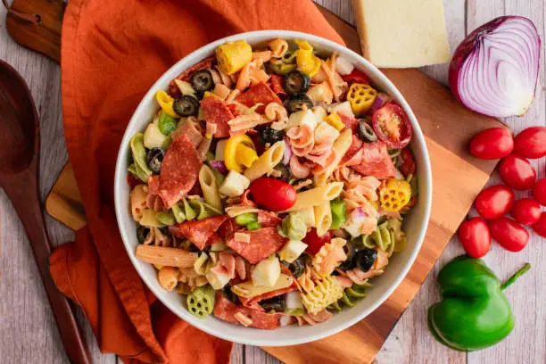 Pasta salad with grape tomatoes, bell pepper, red onion, and more