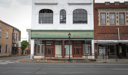 A historic building with a green awning in Greenville, Texas