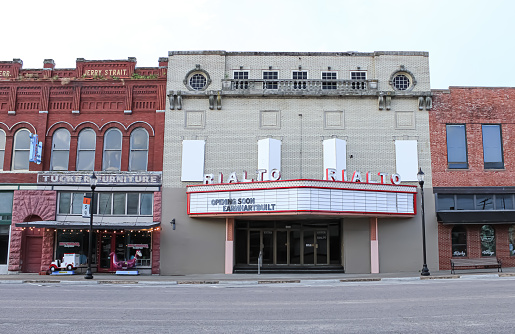 A historic theater building with unique features in the early morning in Denison, Texas