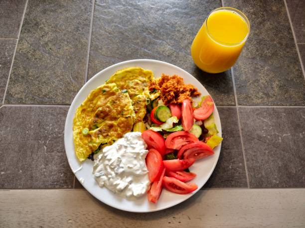 Saturday weekend breakfast eggs omelet tzatziki yogurt vegetables tomatoes cucumber salad and fresh orange juice