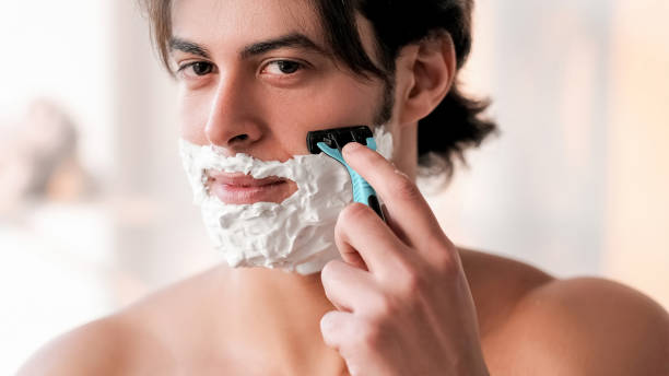 istock Shaving procedure facial grooming man using razor 1501242125