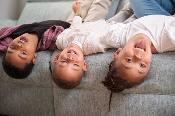 istock Kids playing upside down on sofa, enjoy and having fun together. 1501245090