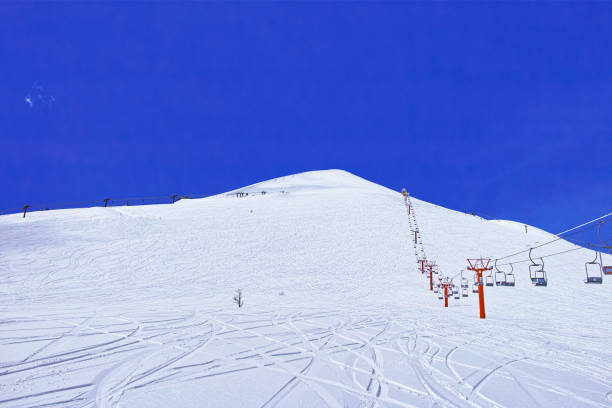 Niseko ski resort Niseko ski resort for spring skiing, Niseko Annupuri summit shining in beautiful blue sky, lift and off-piste trail japanese snowboarder stock pictures, royalty-free photos & images