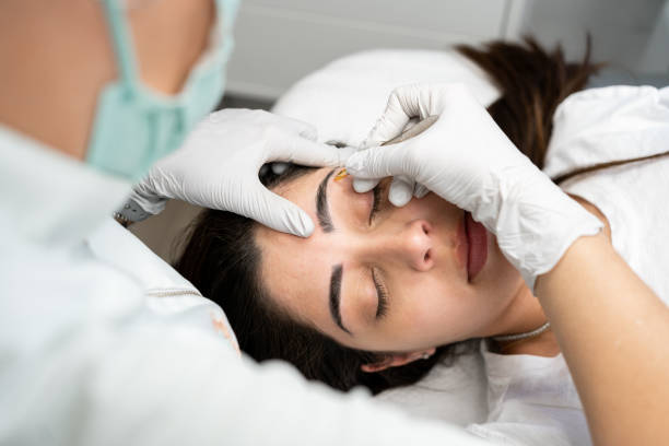 istock Client getting her eyebrow done by a female aesthetician 1501245774