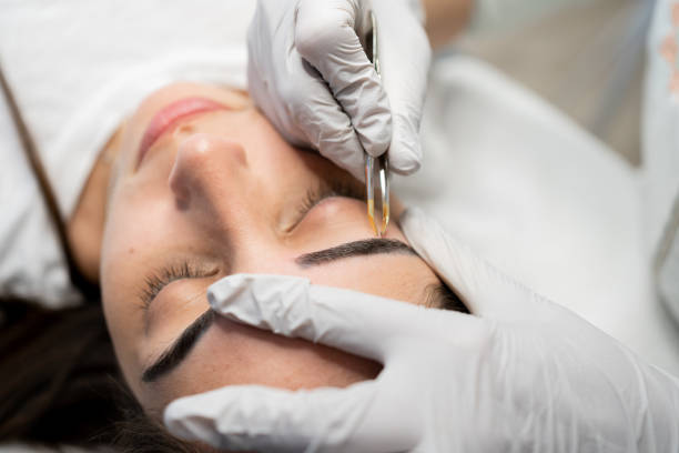 istock Client getting her eyebrow done by a female aesthetician 1501245783