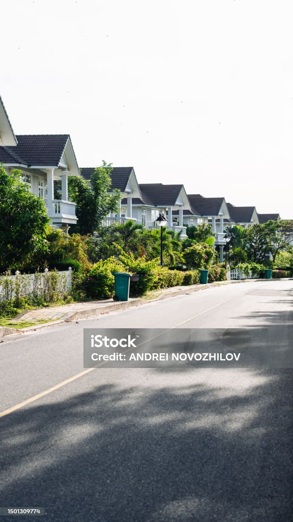 Modern cottages row road sidewalk two story buildings residential villas village New Estate Reflection dawn Sun in windows Modern cottages row road sidewalk two story buildings residential villas village New Estate Reflection dawn Sun in windows. Renton Stock Photo