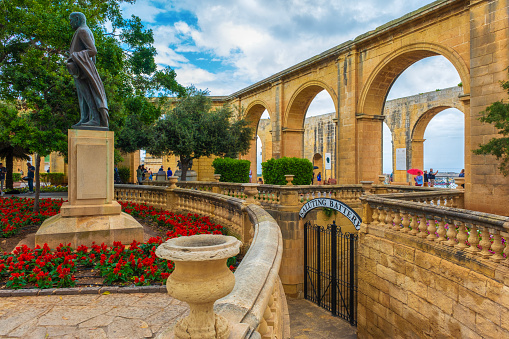 The Upper Barrakka Gardens are a public garden in Valletta, Malta. Along with the Lower Barrakka Gardens in the same city, they offer a panoramic view of the Grand Harbour. The gardens are located on the upper tier of Saints Peter and Paul Bastion. Lord Strickland Statue is located at the left of image. He was prime minister of Malta between 1924 - 1932.\n\nValletta is an administrative unit and the capital of Malta which is an island country in Southern Europe, located in the Mediterranean Sea.