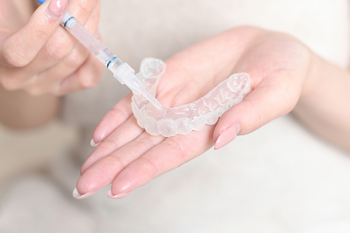 Image of applying gel to home whitening mouthpiece