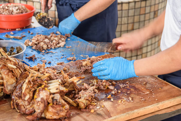 istock Cookers are cutting meat from plov (pilaf) for serving, Tashkent 1501384127
