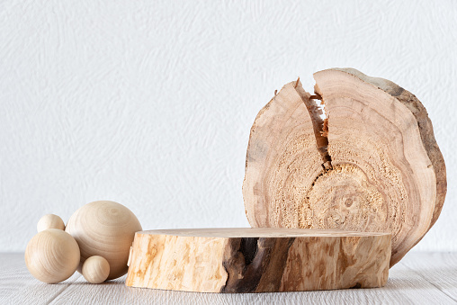 Wooden cross sections as a pad, wooden abstract sculpture. Background for products cosmetics, food or jewellery. Mock up.