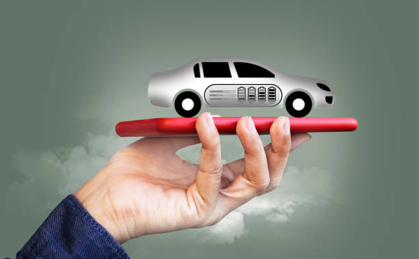 istock EV concept with person using a smartphone. Reducing carbon footprint; charging stations, battery tech enhance fuel efficiency, combat climate change 1501387367