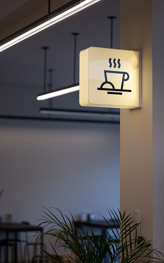 An image of a coffee shop sign in a contemporary building interior