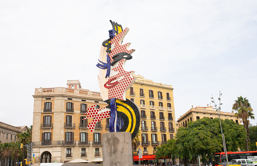Barcelona, Spain - October 16, 2022: head sculpture monument in Barcelona downtown harbor, at summer colors and blue sky.