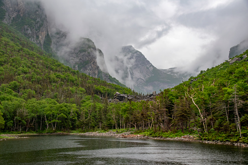 The Western Brook Pond in Gros Morne National Park, Newfoundland is seen on a gloomy, overcast, and rainy day. The Western Brook Pond was one of the highlights of the whole trip, although in reality I enjoyed every place I went. A UNESCO World Heritage site, the pond is technically not a pond - it's a lake. It used to be a fjord, but it lost that designation. The guide explained why, but I don't remember what he said. The pond was gorgeous - at the end of the tour, the guide told us that anyone who hadn't paid for the second part of the ticket had to get off there. Haha, very funny. The parking lot is a 3 kilometre hike away from the boat dock, but it's not a strenuous hike, and it does come with some beautiful scenery. As you can see in this picture, it was quite a gloomy day - great for pictures, but not so great for hiking. I got rained on during the entire boat tour as well as the hike back.