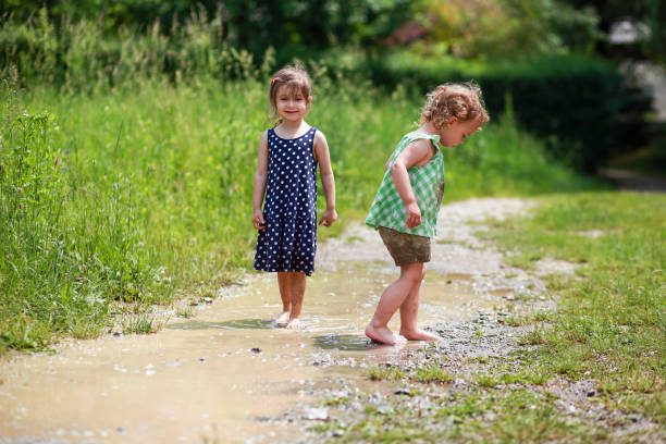 istock Two little girls in mud puddles 1501450852
