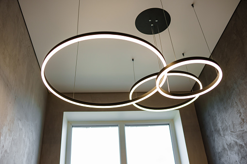 Modern ceiling lamp of three rings. Minimalism in the interior.