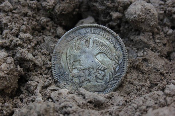 istock 1843 Mexican Libertad Silver Coin on Ground in Dirt Back View 1501473623