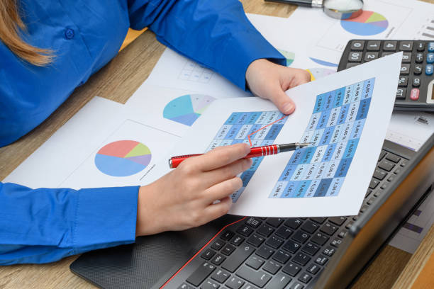 istock A woman working in the office holds paper documents in her hand 1501478456