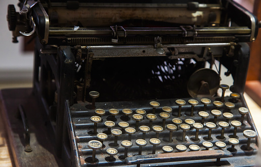 Vintage black typewriter with latin letters close up.