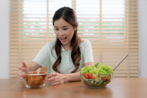 Asian woman gave up vegetables and switched to fast food.