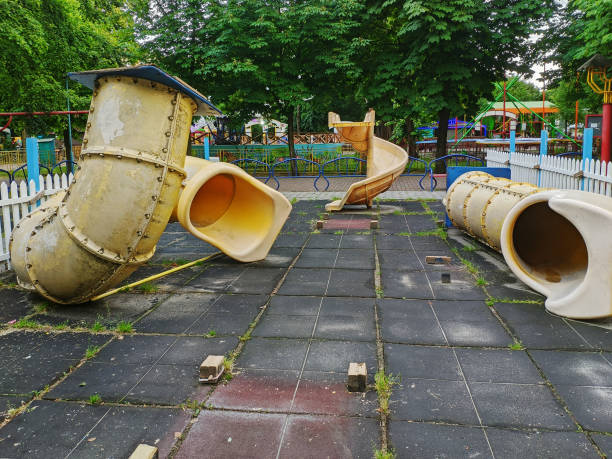 Broken playground with slides in an amusement park on a summer day stock photo