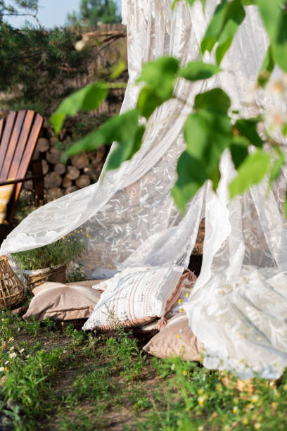 istock A white net canopy with a chandelier and cushions hangs from a pine tree in the garden 1501485781