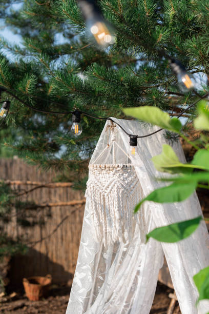 istock A white net canopy with a chandelier and cushions hangs from a pine tree in the garden 1501485787