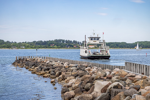 Kulhuse, Denmark - June 15th 2023: Small traditional ferry crossing Roskilde Fjord northwest of Copenhagen