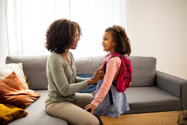 istock Mother helping her daughter to get ready for school 1501493687