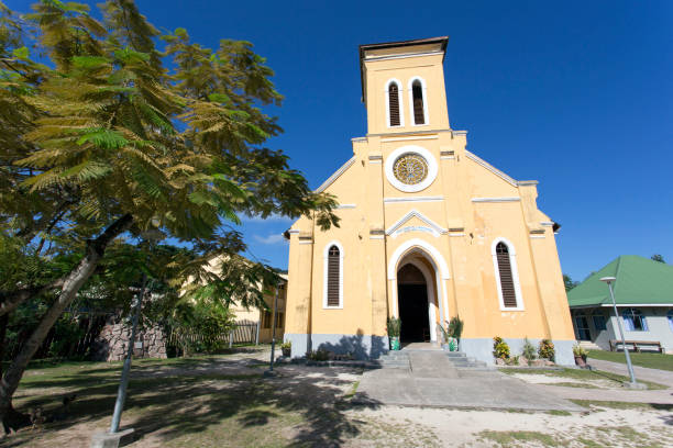 Notre-Dame de l'Assomption Church from the year 1877 on La Digue Island. Aerial Drone Point of view towards the colorful Catholic Mission Church on La Digue Island. La Digue, Seychelles Island, East Africa