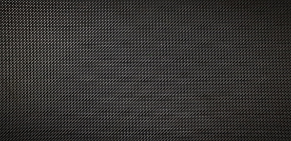 A macro image of a very fine black grid from a microphone.