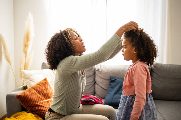 istock Mother helping her daughter to get ready for school 1501495202