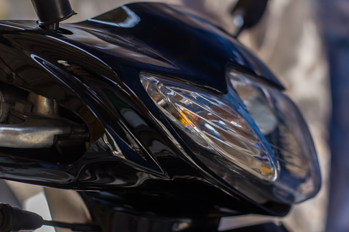 Close-up of a motorbike parked on a pavement