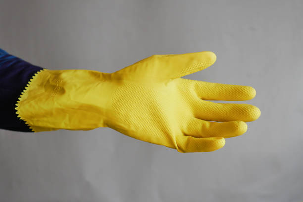 istock men wearing a yellow color cleaning gloves 1501497379