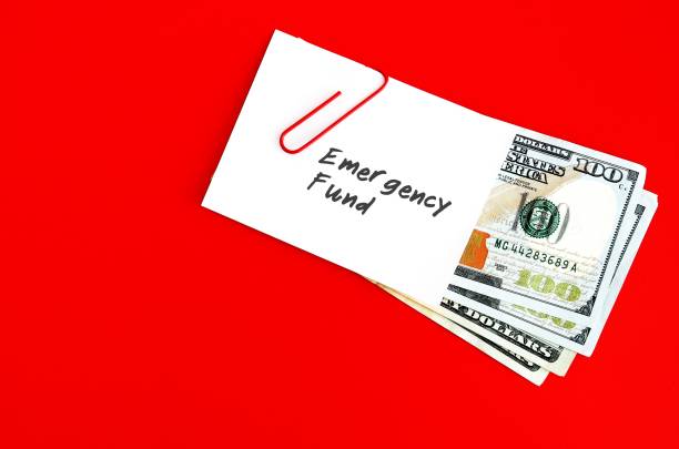 istock White paper note with text written EMERGENCY FUND clip with cash dollars money on red copy space background , concept of saving money for crisis emergency tough time 1501544937