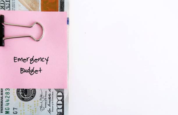 istock Cash money on white copy space background with text written note EMERGENCY BUDGET, cash reserve that's specifically set aside for unplanned expenses or financial emergencies 1501544954