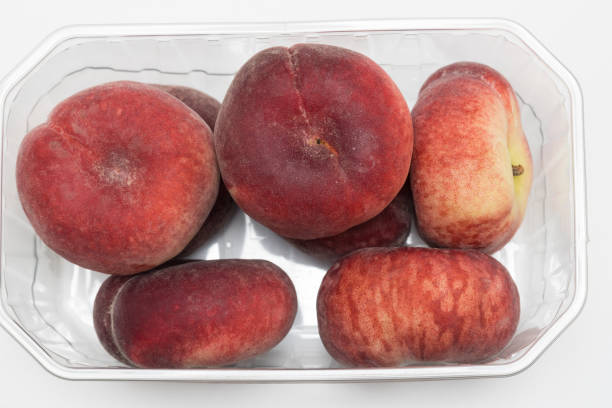 istock plastic tub of Paraguayan, flat or button peach 1501558094
