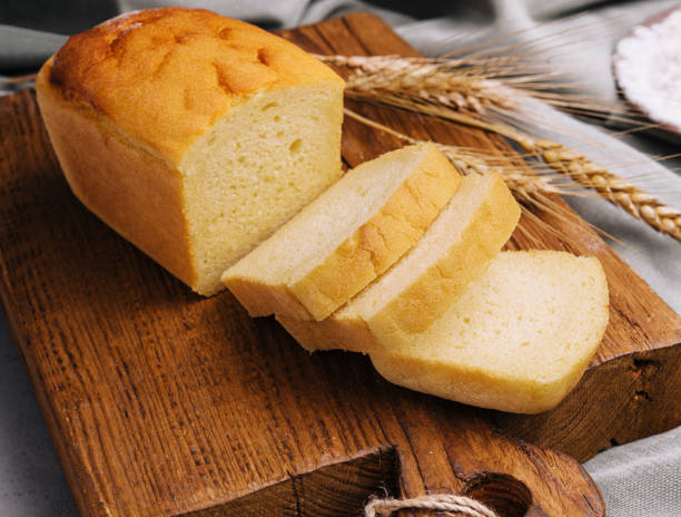 istock Fresh bread on wooden board closeup 1501575580