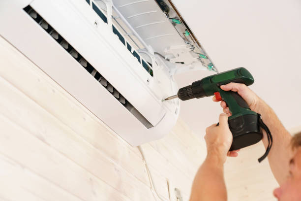 istock A man unscrews an air conditioner on the wall with a screwdriver 1501581072