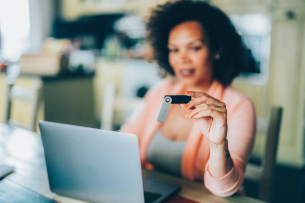 istock Woman at home using Hardware Wallet for cryptocurrency 1501586554