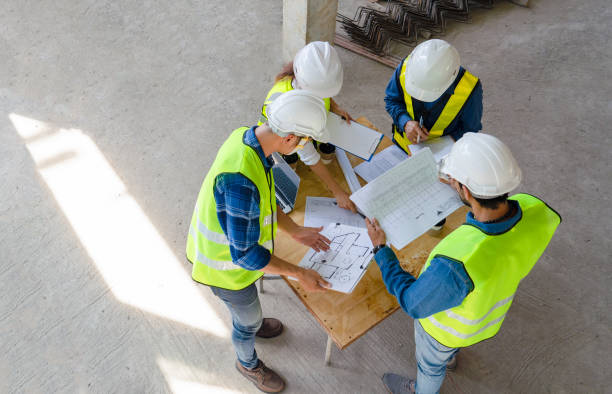 istock team of civil technician engineers discuss the timeline with architect foreman worker while inspecting, check safety infrastructure construction progress for sustainable green building at project site 1501592337