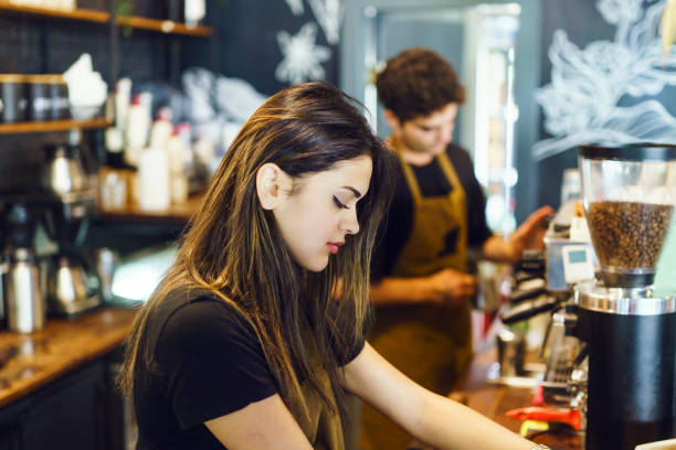 istock Two young baristas operating a coffee machine together at a cafe 1501620088