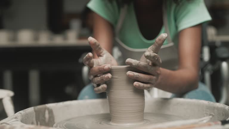 Teenager girls is making pottery as leisure activity.