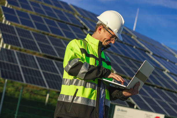 istock Male engineer using laptop,solar panels in background 1501653444