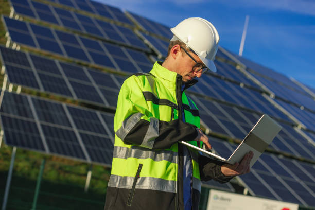 istock Male engineer using laptop,solar panels in background 1501653445