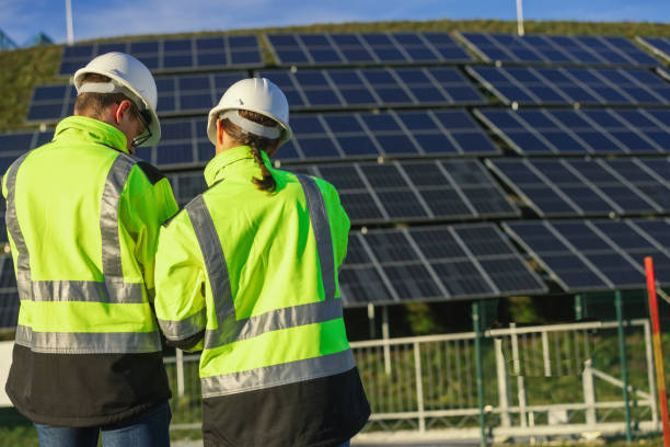 istock Two engineers discussing operation of solar power station 1501653483