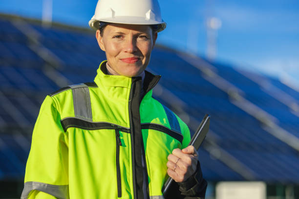 istock Female engineer with digital tablet in front of solar panels 1501654070