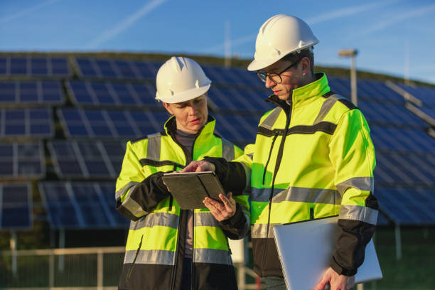 istock Two engineers discussing operation of solar power station 1501656337