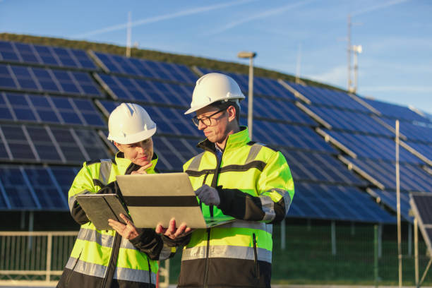 istock Two engineers discussing operation of solar power station 1501656931